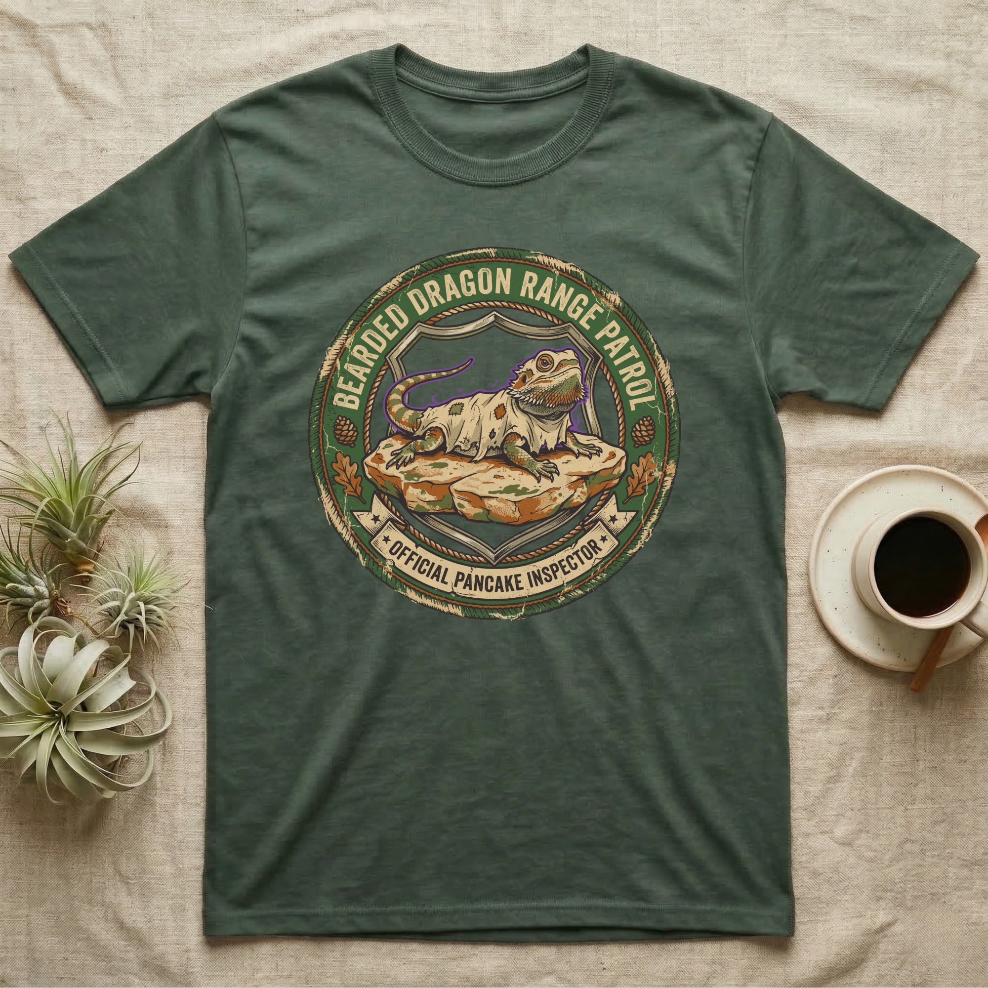 Bearded Dragon Pancake Inspector T-Shirt in Military Green — Weathered ranger badge of a bearded dragon flattened on a rock, "Bearded Dragon Range Patrol, Official Pancake Inspector."