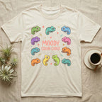 Chameleon Moody T-Shirt in Natural — Ten cartoon chameleons in different colours and moods around the coral-pink words MOODY COLOR-CODED