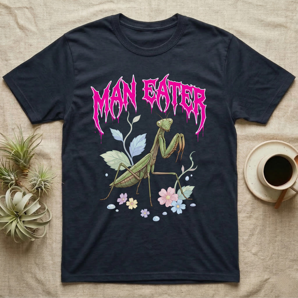 Chinese Mantis Feral T-Shirt in Navy — Pastel Chinese mantis with raised spiked forelegs among leaves and blossoms, jagged magenta metal wordmark "MAN EATER" above.
