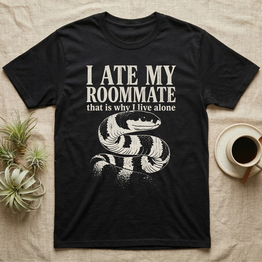California Kingsnake Ate My Roommate T-Shirt in Black — One-ink white California kingsnake portrait on black, black-and-cream banding, under the words I ATE MY ROOMMATE and that is why I live alone.