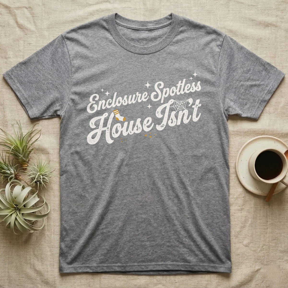 Terrarium Spotless House T-Shirt in Sport Grey — Retro script reading Enclosure Spotless with sparkles above grubby lettering reading House Isn't with a sock, cobweb and crumbs