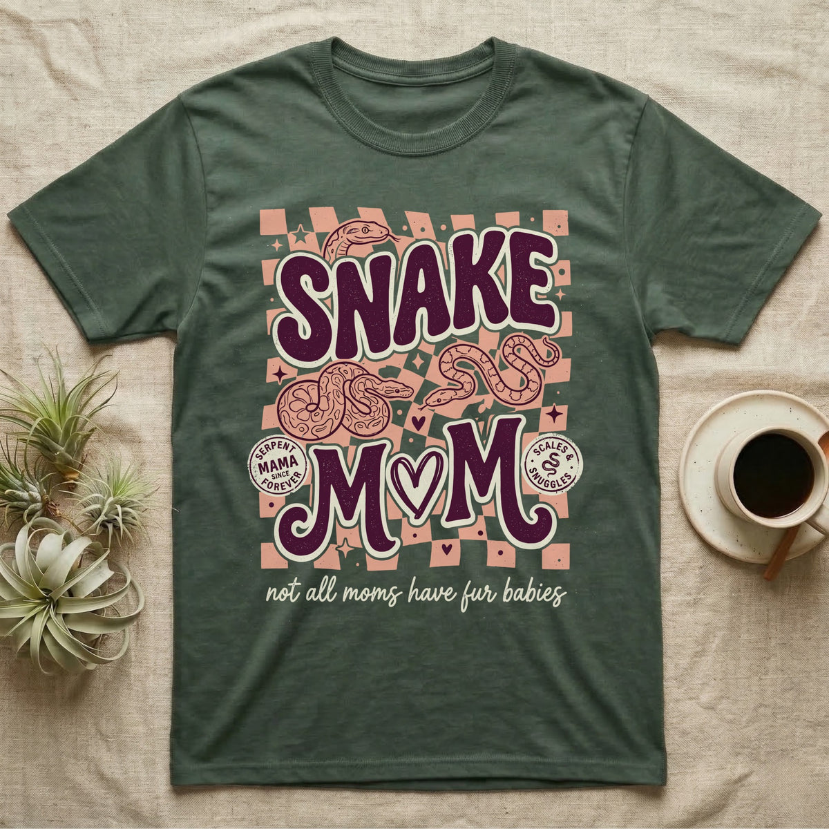 Green t-shirt with "Snake Mom" text and stylized snakes.