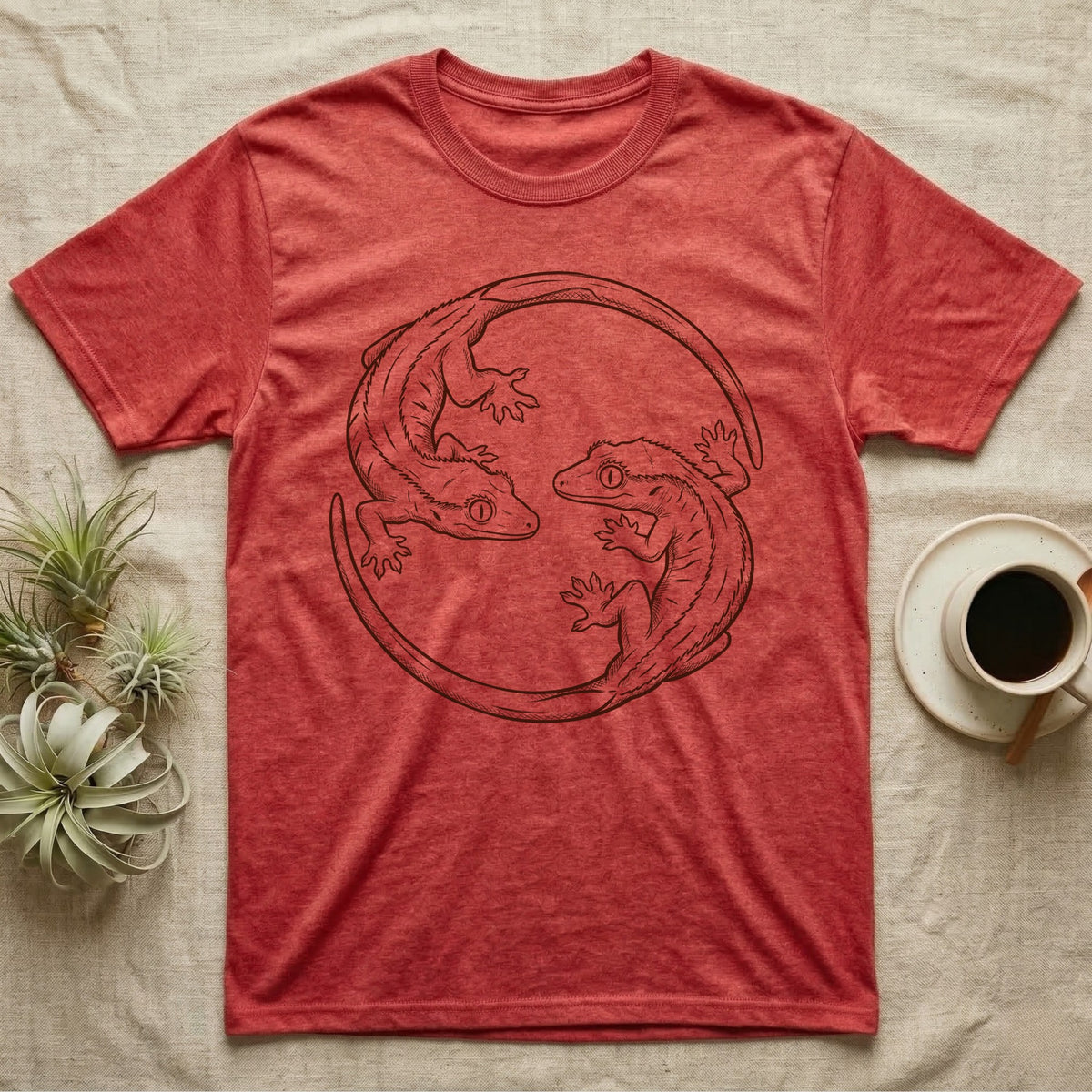 Crested Gecko Roundel T-Shirt in Heather Red — Two crested geckos in mahogany brush line art, rotated 180 degrees into a circular roundel closed by their own tails.