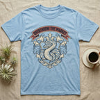Overthrow The Market Python T-Shirt in Light Blue — Vintage heraldic-crest illustration of a regal ball python with a banner reading "Overthrow The Market."