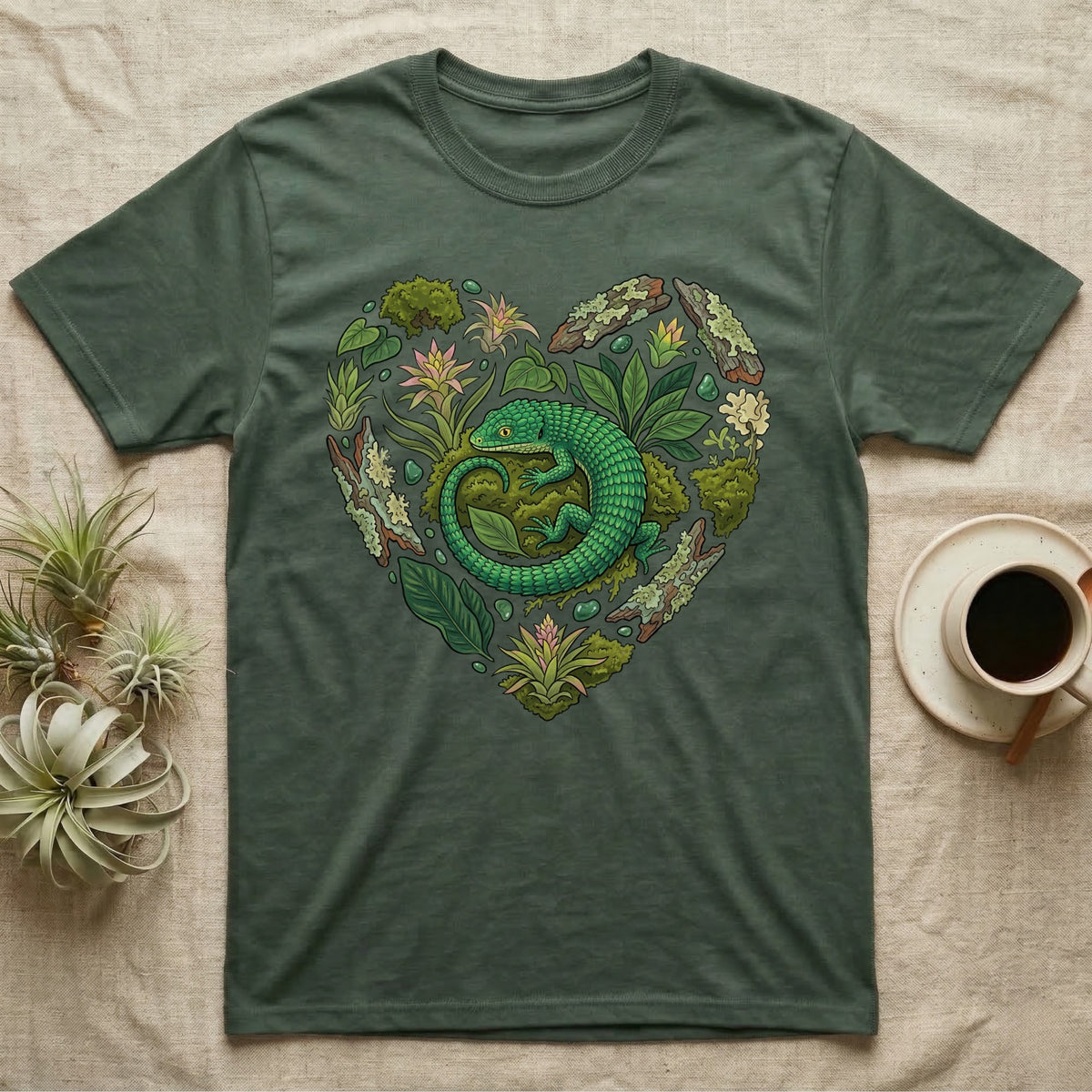Green t-shirt with a heart-shaped design of a lizard and foliage.