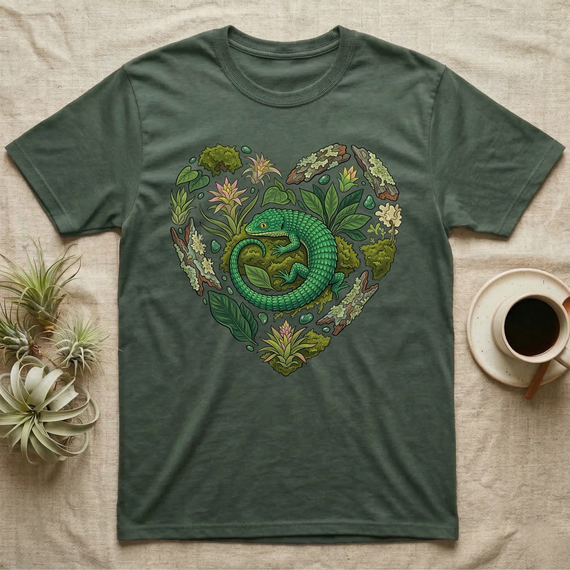 Green t-shirt with a heart-shaped design of a lizard and foliage.