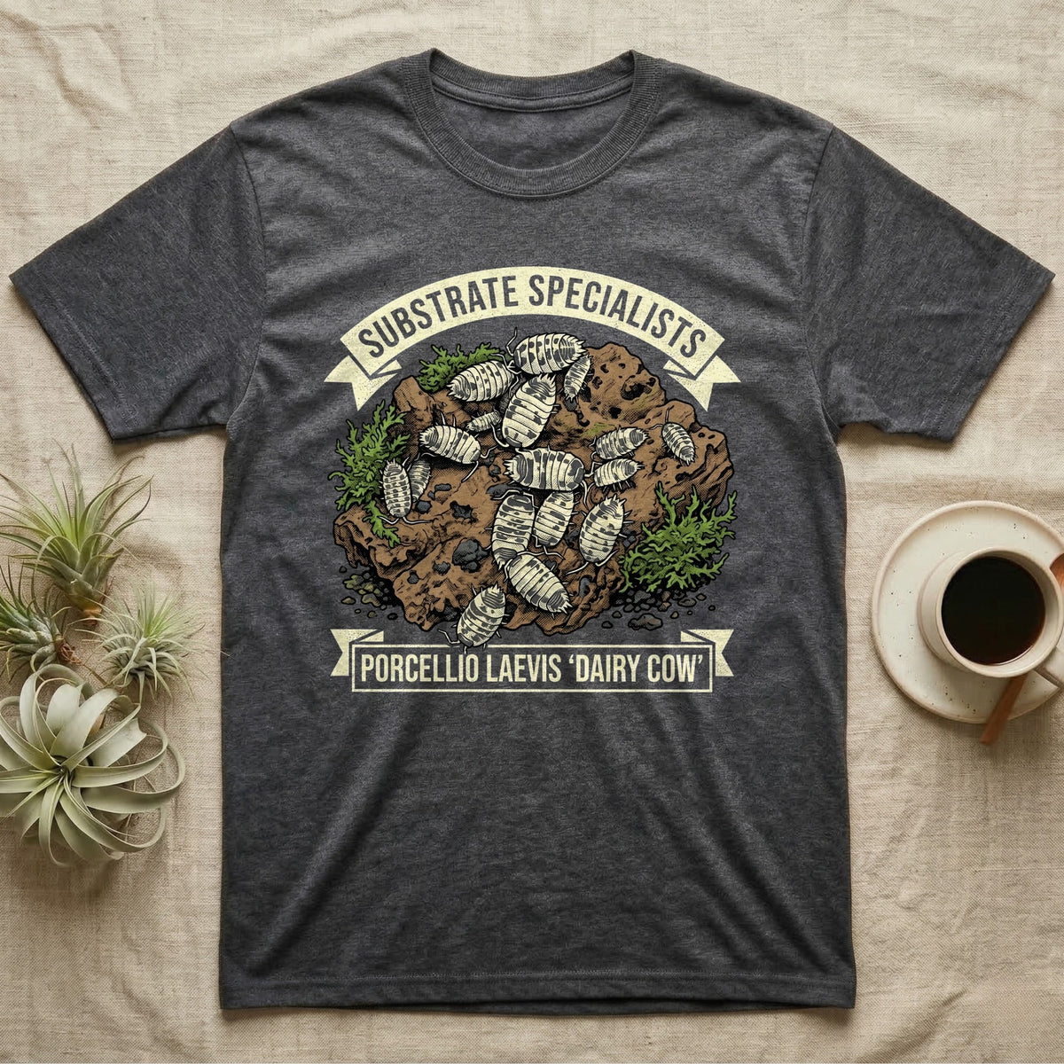 Dairy Cow Isopod Substrate Specialists T-Shirt in Dark Heather — Vintage print of a dairy cow isopod colony on a mossy soil clod between "Substrate Specialists" banners.