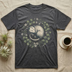 Dark grey t-shirt with sleeping opossum in floral wreath design.