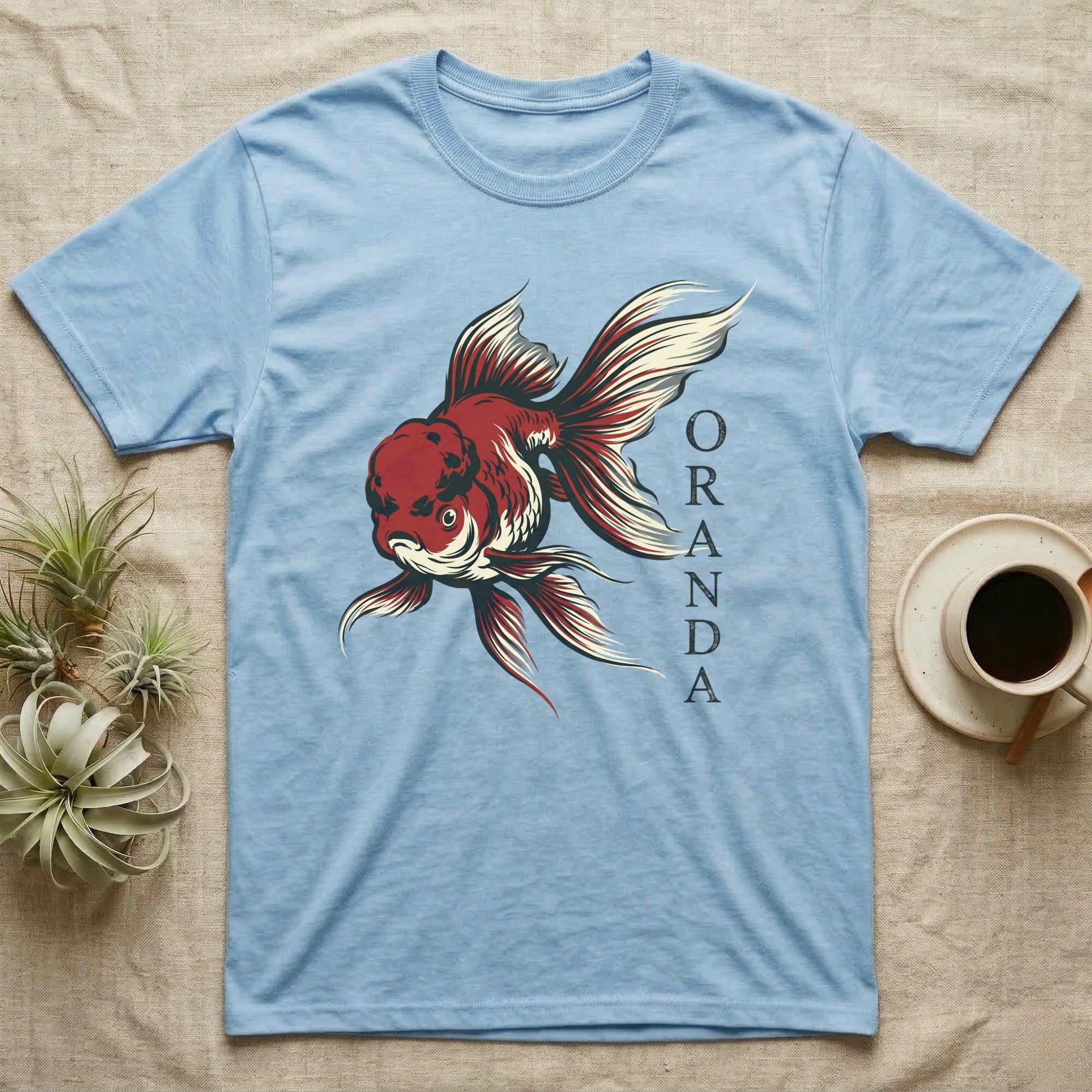 Light blue t-shirt with red and white oranda goldfish graphic.