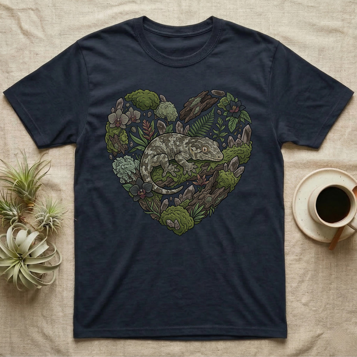 Navy t-shirt with heart-shaped gecko and forest elements design.