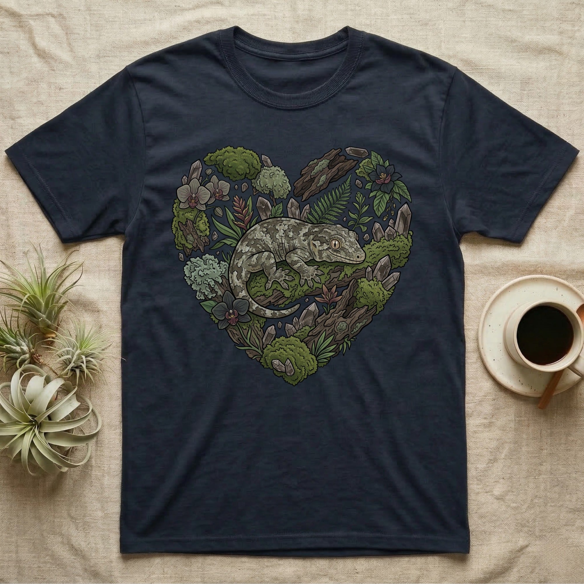 Navy t-shirt with heart-shaped gecko and forest elements design.