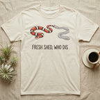 Milk Snake Shed T-Shirt in Natural — Glossy red, black and white milk snake with its tail still in its translucent shed skin above the words FRESH SHED, WHO DIS