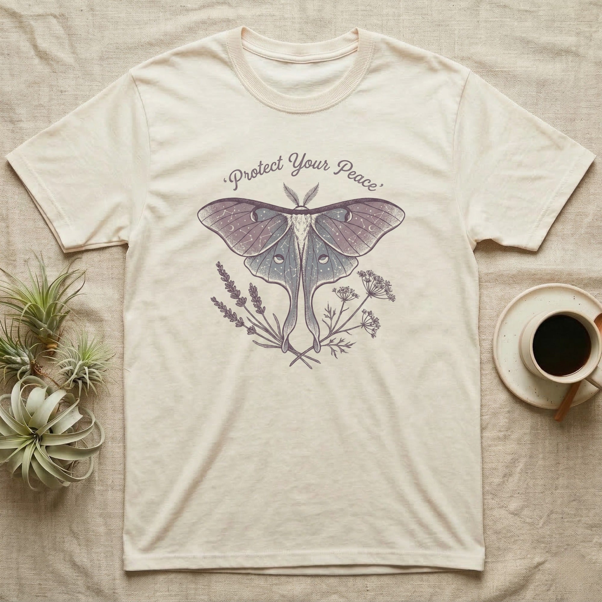 Cream t-shirt with moth and floral graphic and text "Protect Your Peace".