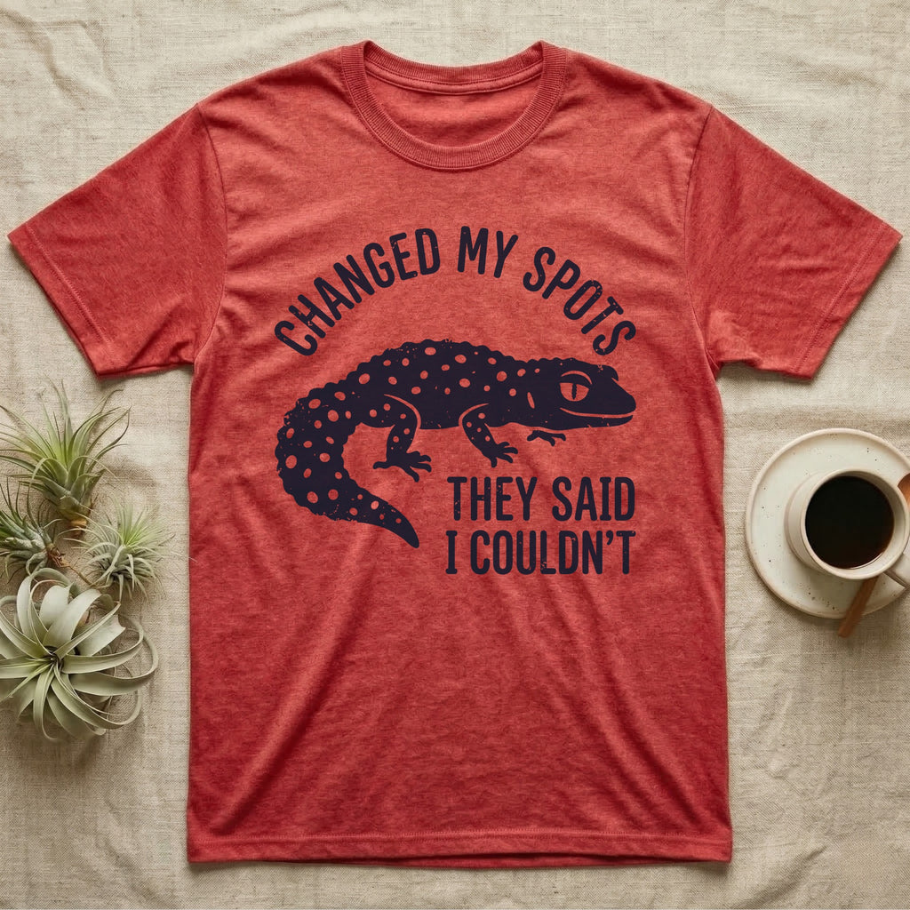 Leopard Gecko Spots T-Shirt in Heather Red — Navy silhouette of a spotted leopard gecko walking under arched words Changed My Spots, beside They Said I Couldn't