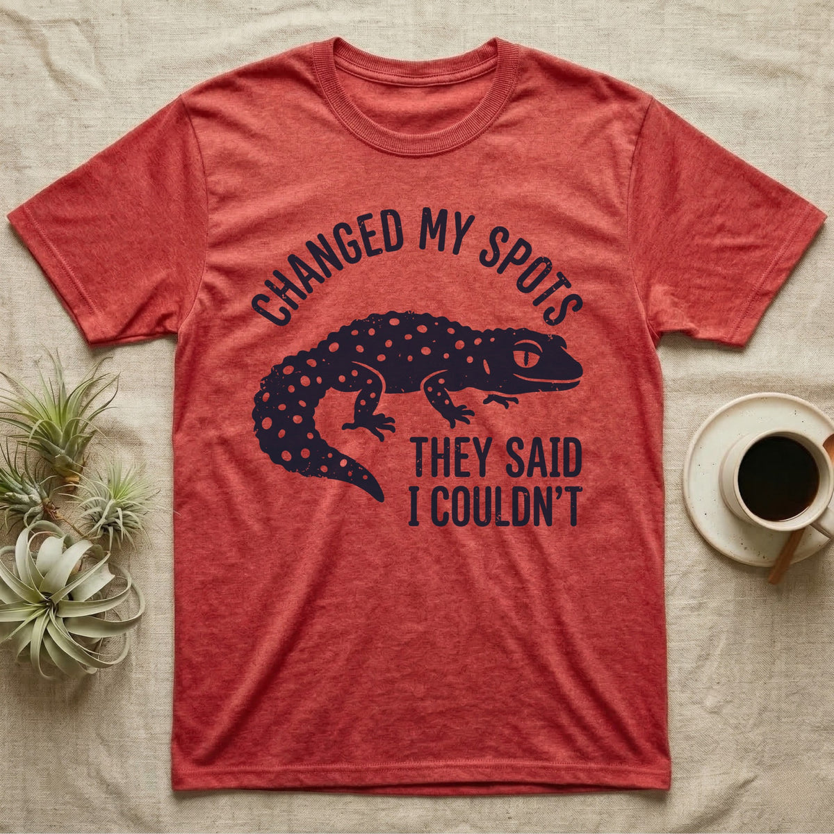 Leopard Gecko Spots T-Shirt in Heather Red — Navy silhouette of a spotted leopard gecko walking under arched words Changed My Spots, beside They Said I Couldn't