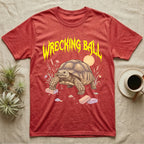 Sulcata Tortoise Feral T-Shirt in Heather Red — Sulcata tortoise plodding over crumbled bricks under a jagged caution-yellow metal "WRECKING BALL" wordmark.