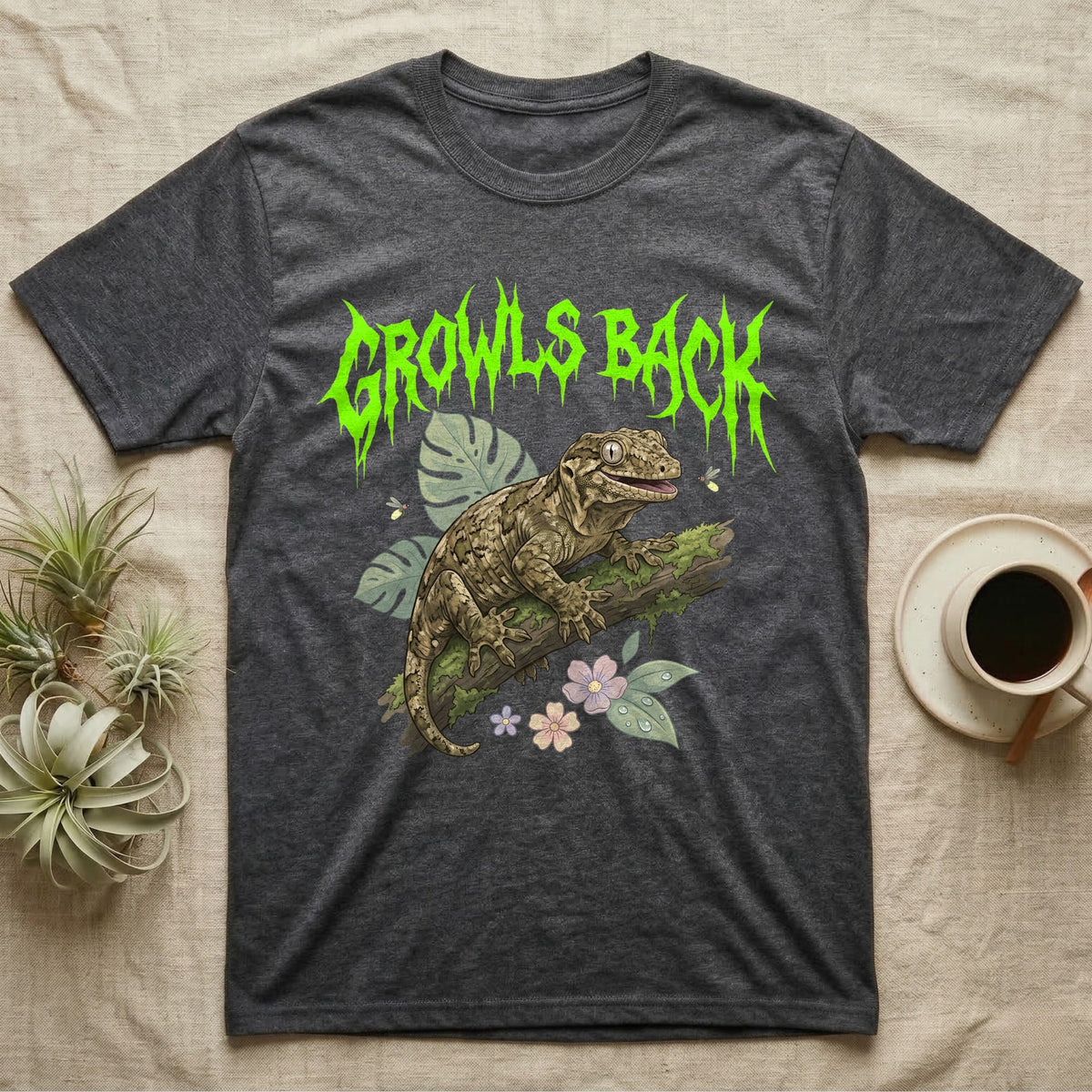 Leachianus Gecko Feral T-Shirt in Dark Heather — Leachianus giant gecko on a mossy branch under jagged lime-green metal text GROWLS BACK with pastel leaves