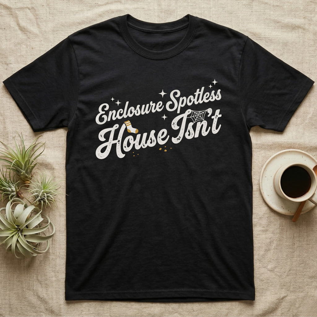 Terrarium Spotless House T-Shirt in Black — Retro script reading Enclosure Spotless with sparkles above grubby lettering reading House Isn't with a sock, cobweb and crumbs