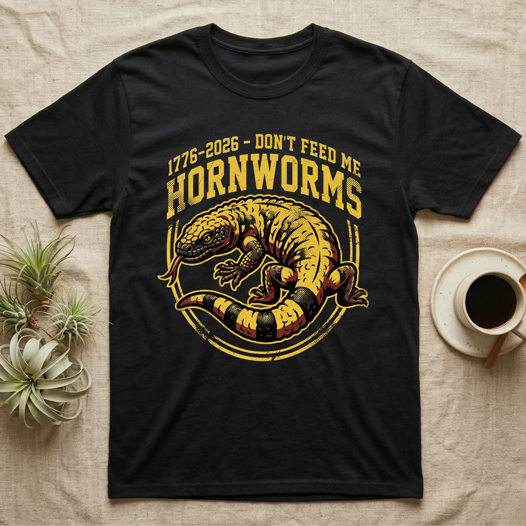 Gila Monster Hornworms Tee in Black — Bold gold and maroon woodcut tee of a Gila monster with banded tail, large text reading Don't Feed Me Hornworms, on black.