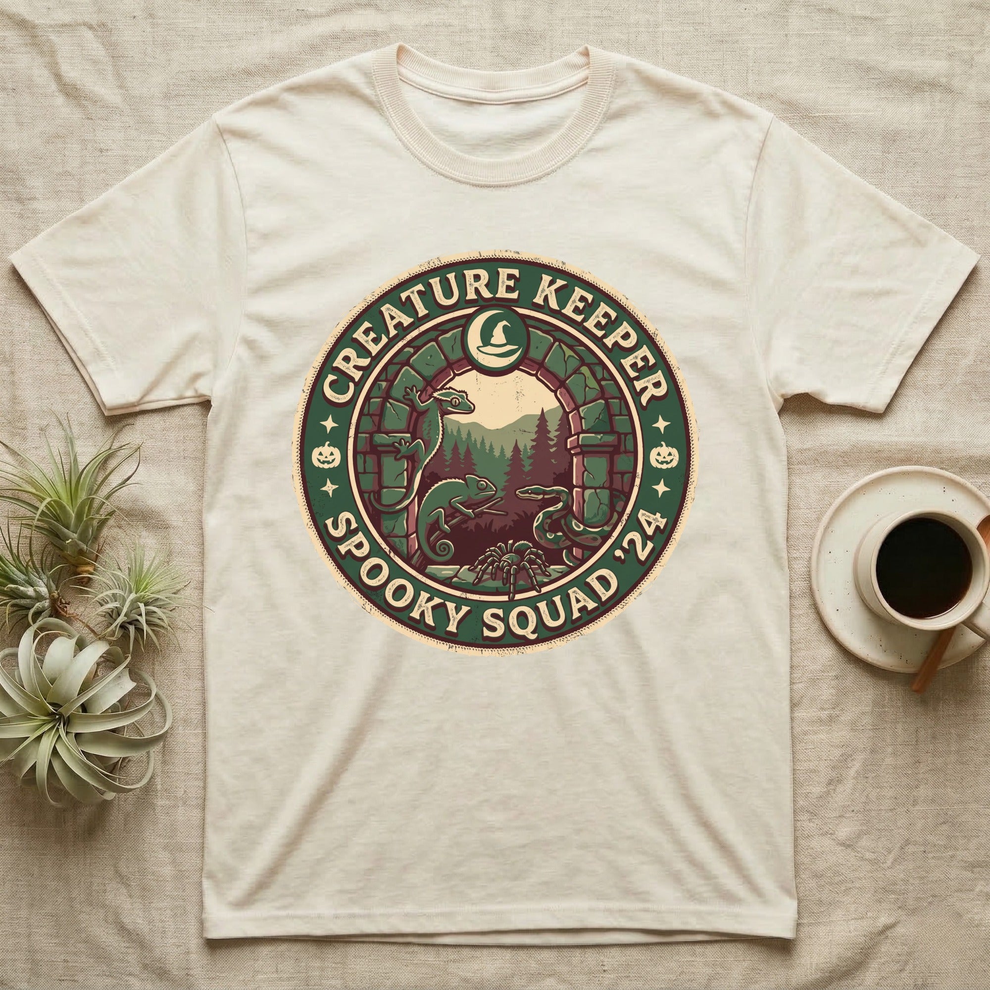 Creature Keeper Spooky Squad T-Shirt in Natural — Embroidered-patch badge with a gecko, chameleon, snake and tarantula in a stone archway, "Creature Keeper Spooky Squad."