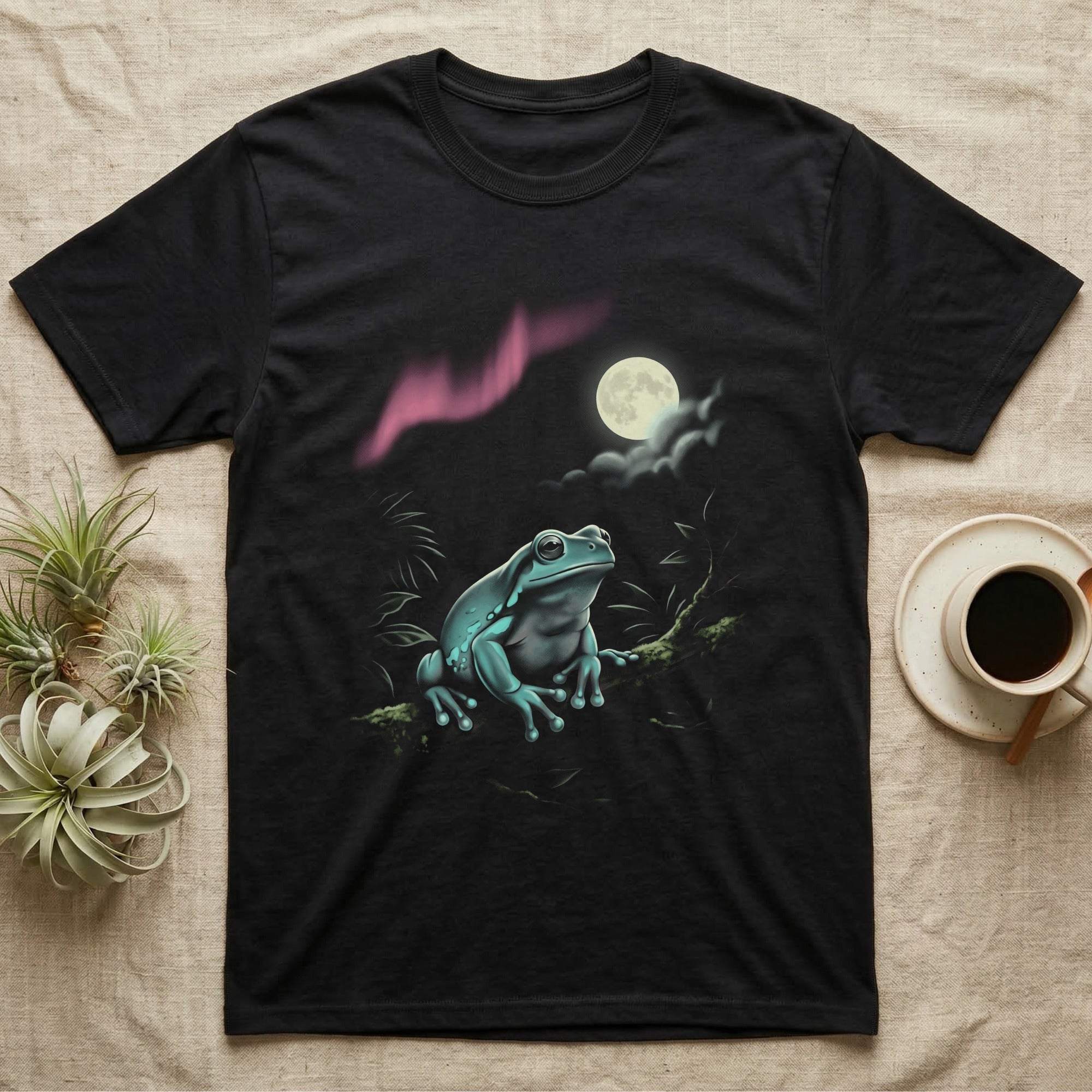 White's Tree Frog Moonlit T-Shirt in Black — Airbrushed White's tree frog rising from moonlit water toward a cream full moon, cyan and pink glow on black.