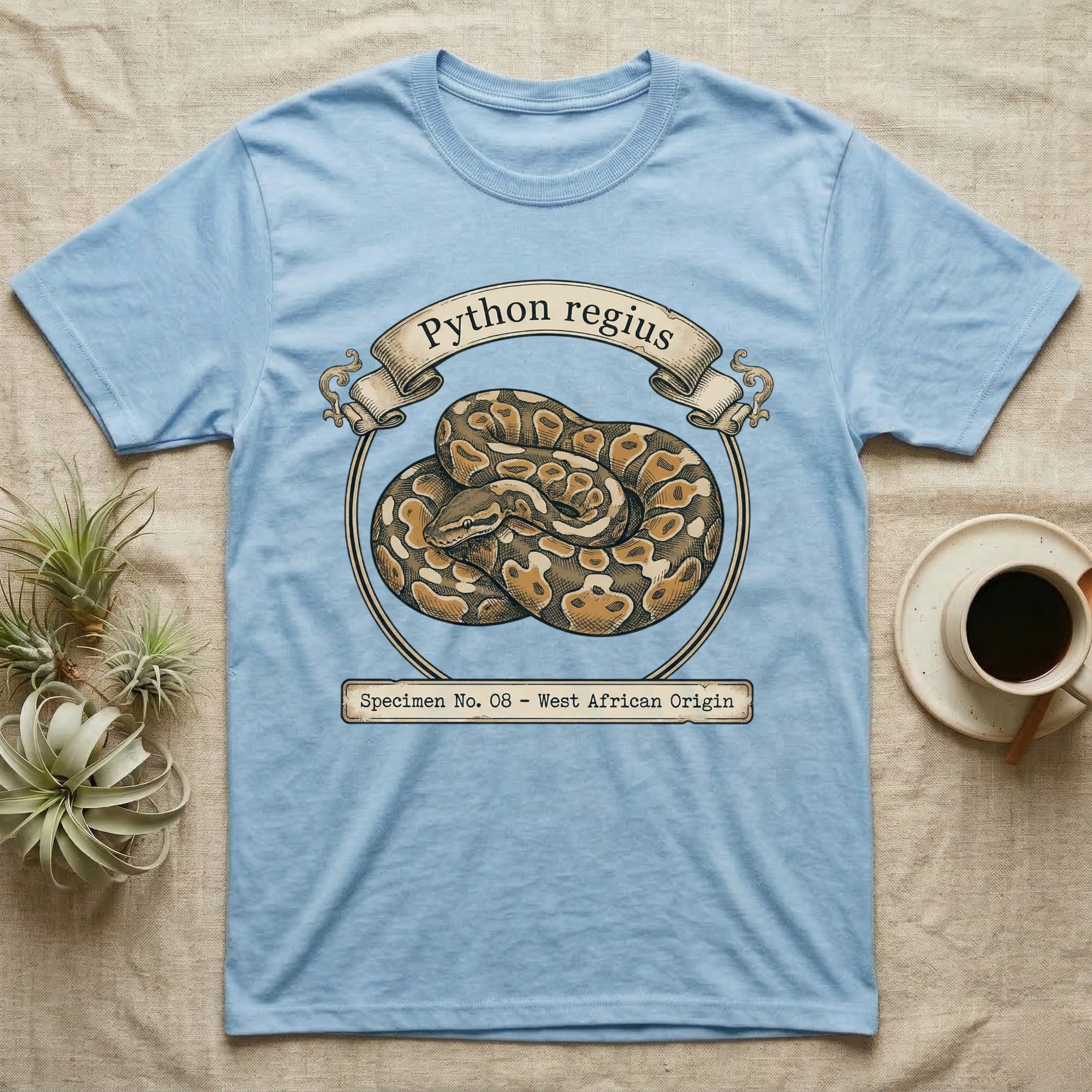 Light blue t-shirt with Python regius illustration and text.