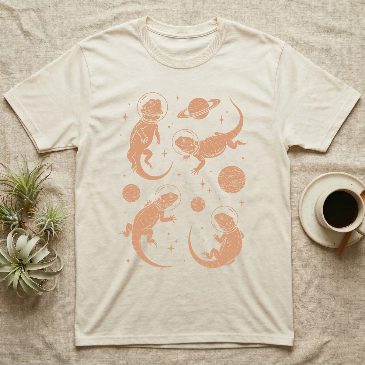 Bearded Dragon Cosmic T-Shirt in Natural — Vintage screen-print illustration of bearded dragons in astronaut helmets floating in space, warm copper monochromatic on dark background.