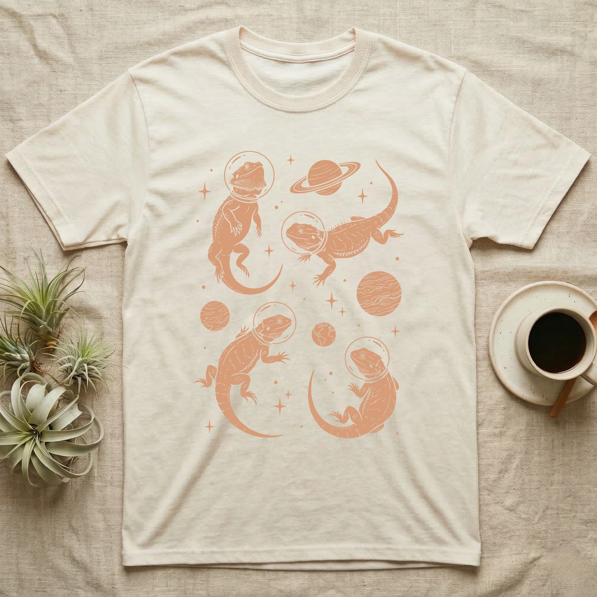 Bearded Dragon Cosmic T-Shirt in Natural — Vintage screen-print illustration of bearded dragons in astronaut helmets floating in space, warm copper monochromatic on dark background.