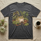 Bioactive Pacman Frog T-Shirt in Dark Heather — Warm botanical illustration of a content pacman frog half-buried in a lush bioactive habitat of moss and leaf litter.