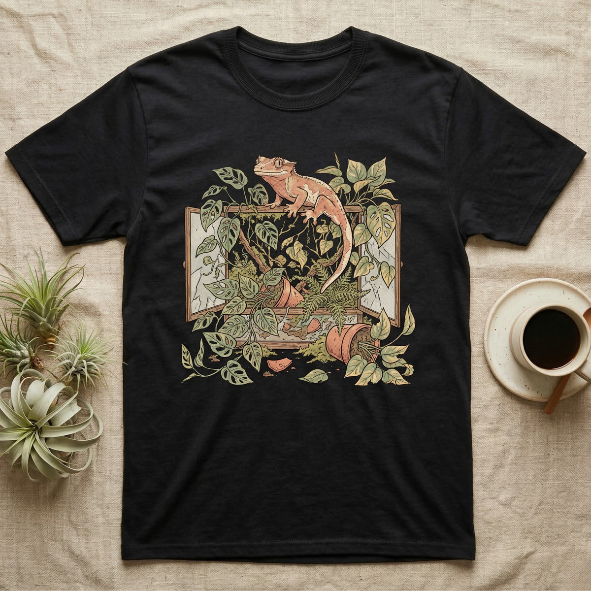 Bioactive Crested Gecko T-Shirt in Black — Botanical illustration of a smug crested gecko perched atop a lush overgrown planted vivarium spilling vines.