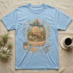 Light blue t-shirt with a terrarium design featuring a gecko and floral accents.