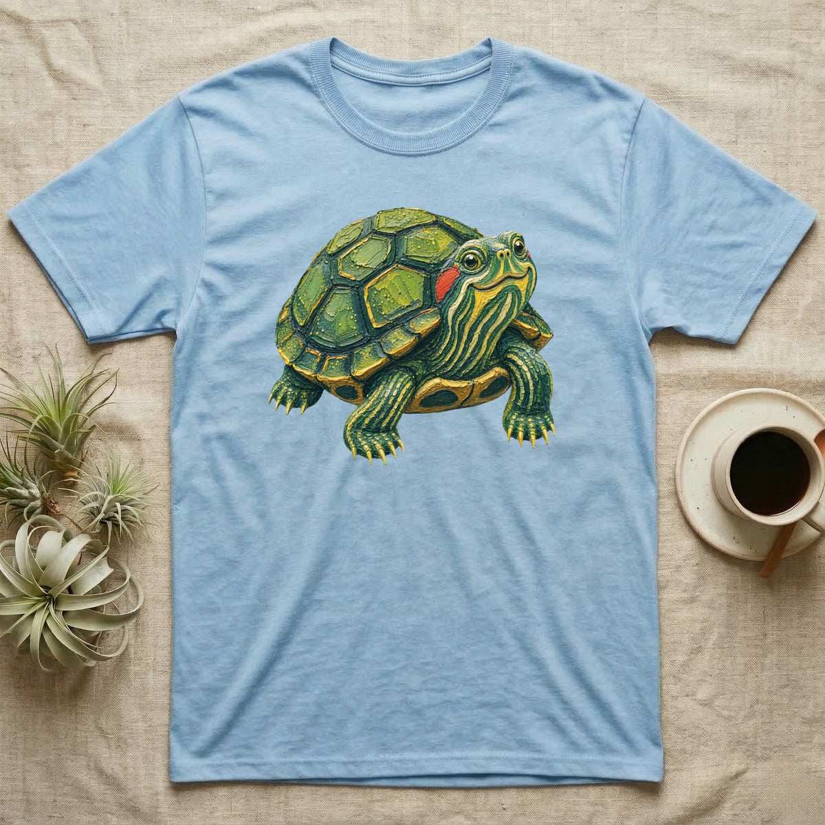Light blue t-shirt with a detailed illustration of a small turtle.