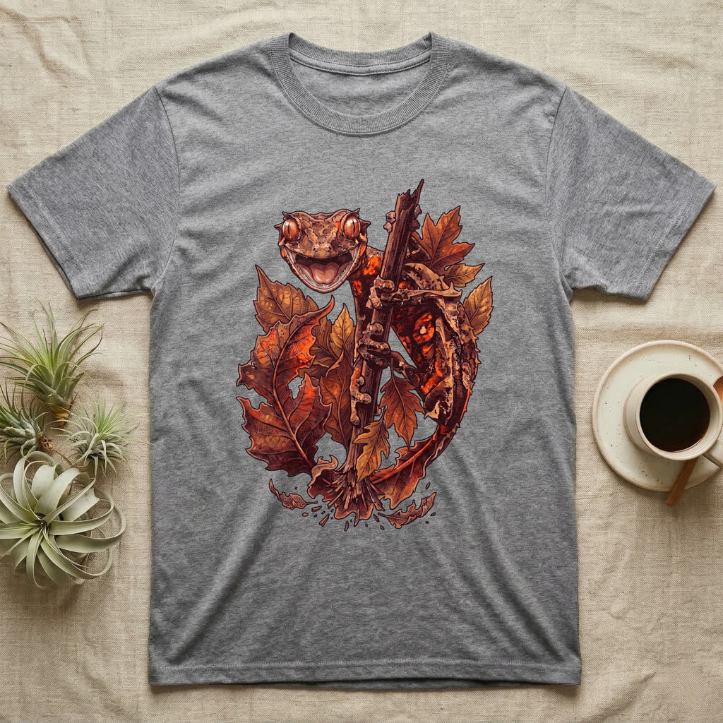 Satanic Leaf-Tailed Gecko Autumn T-Shirt in Sport Grey — Painted illustration of a satanic leaf-tailed gecko gripping a bare stem among dried autumn leaves in rust and amber, no on-shirt text.