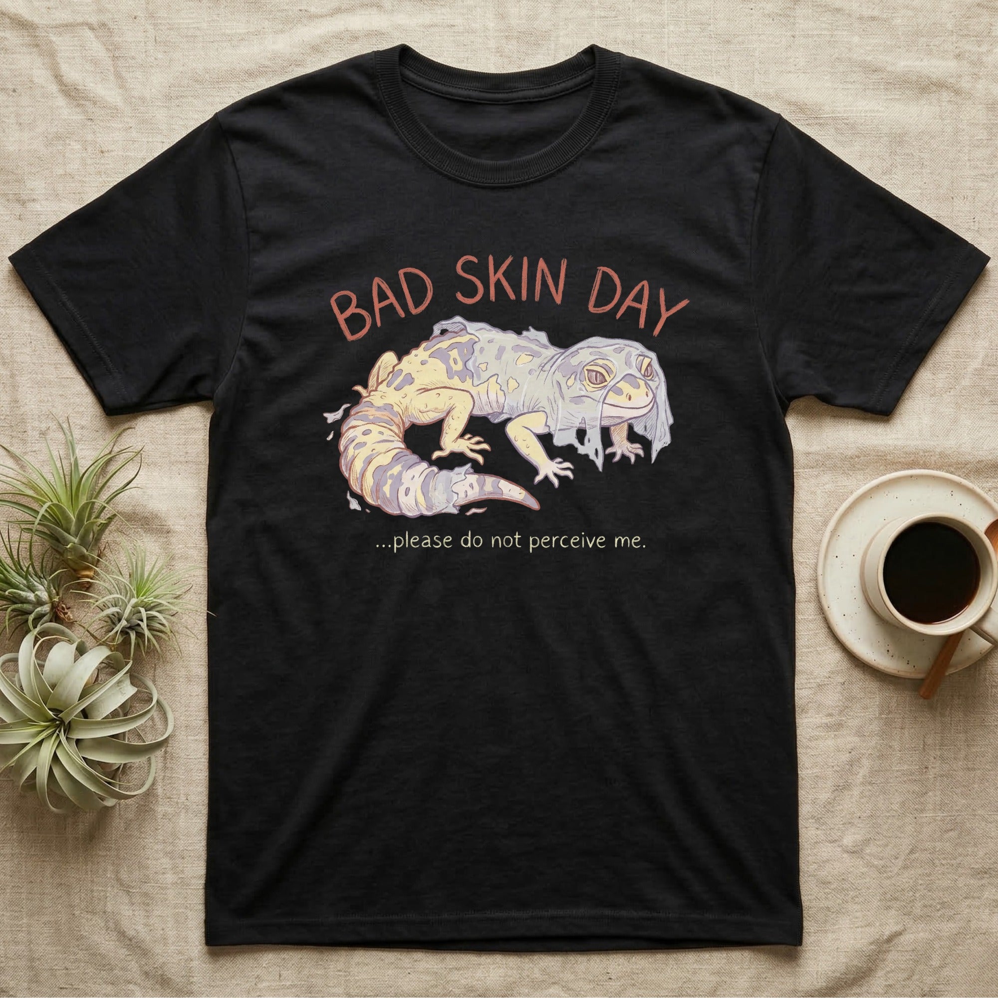 Black t-shirt with leopard gecko illustration and text "BAD SKIN DAY".