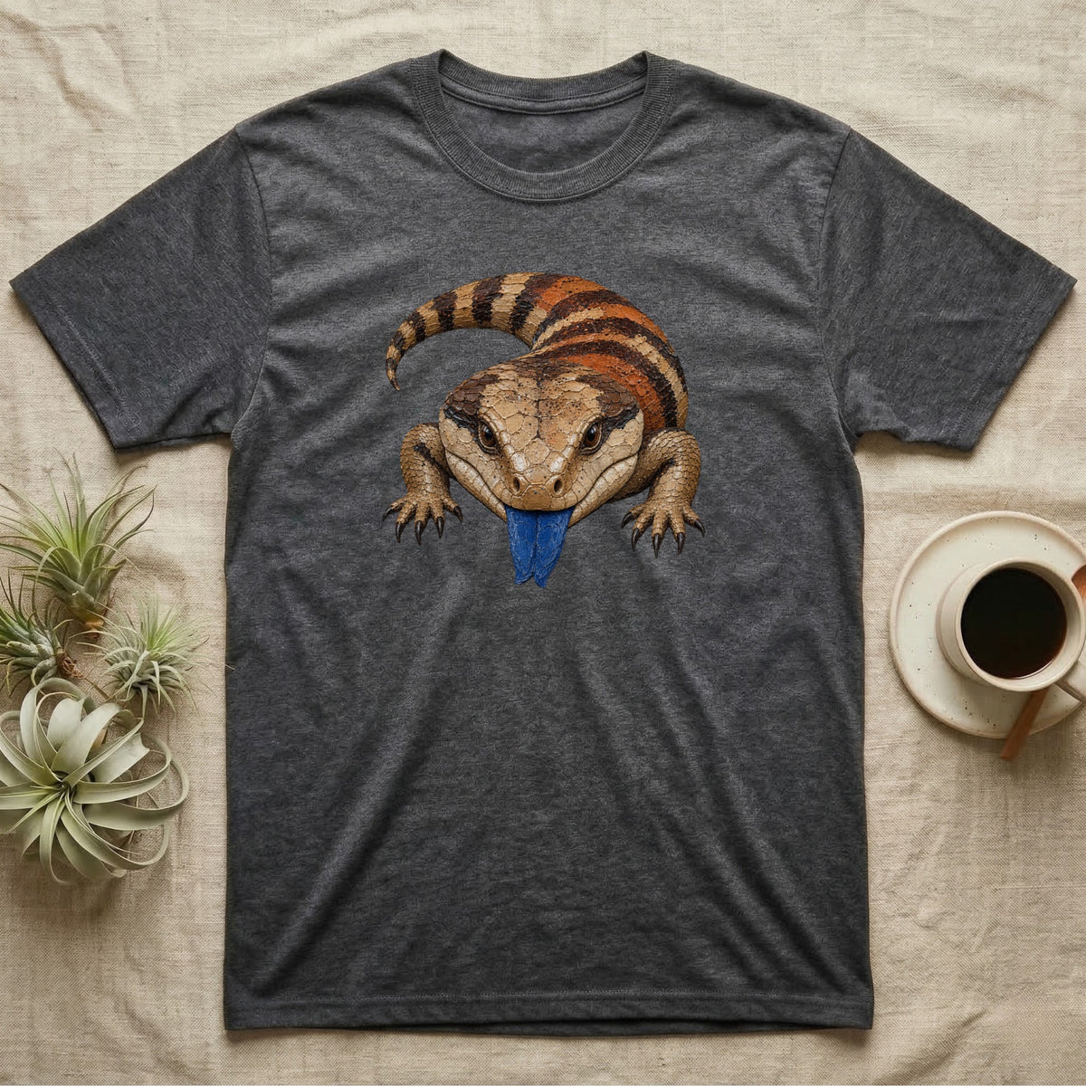 Dark grey t-shirt featuring a blue-tongued skink illustration.