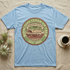 Isopod Terrarium Keepers Union T-Shirt in Light Blue — Vintage union badge showing a cross-sectioned bioactive vivarium worked by isopods and springtails.