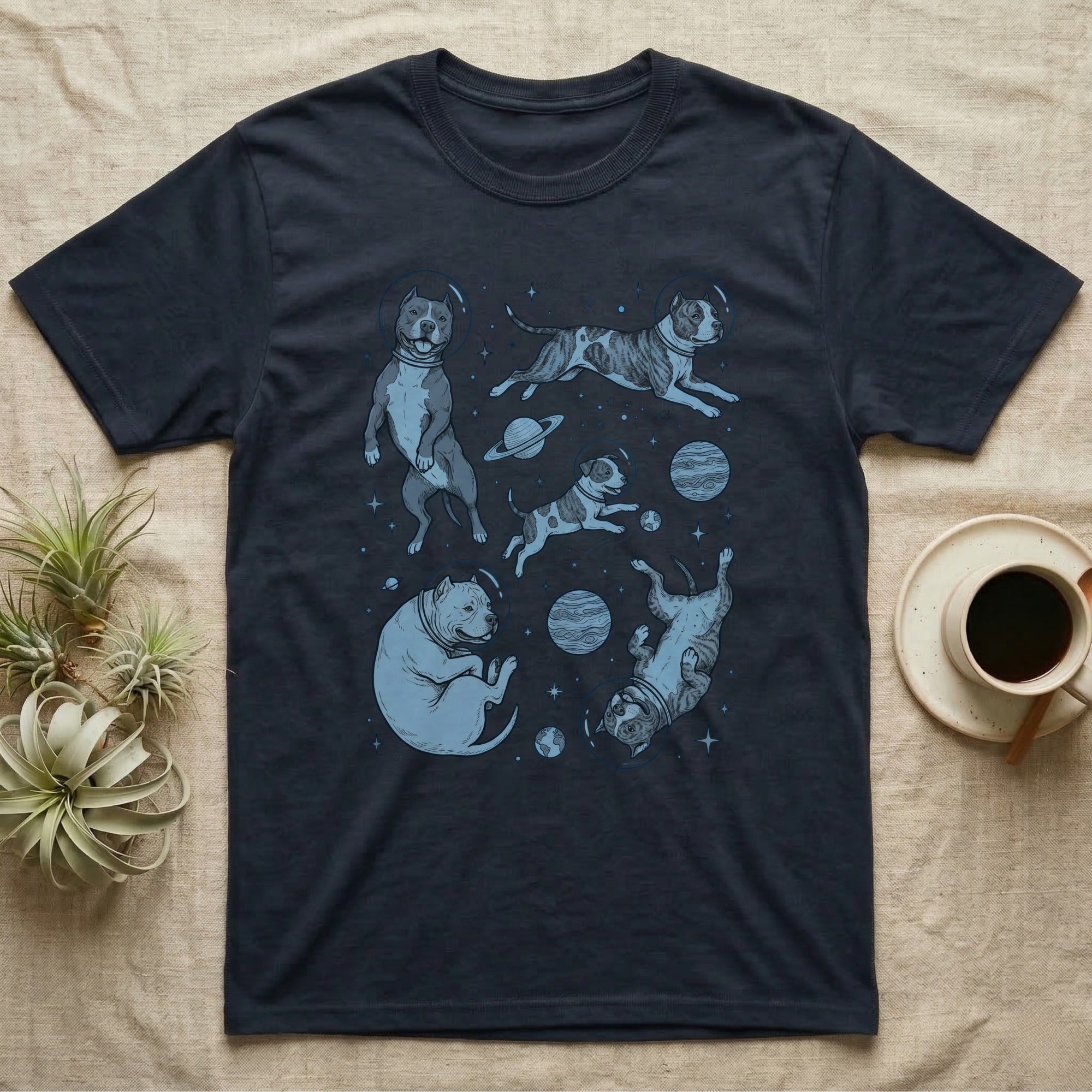 Dark t-shirt with scattered illustrations of pit bulls in space.