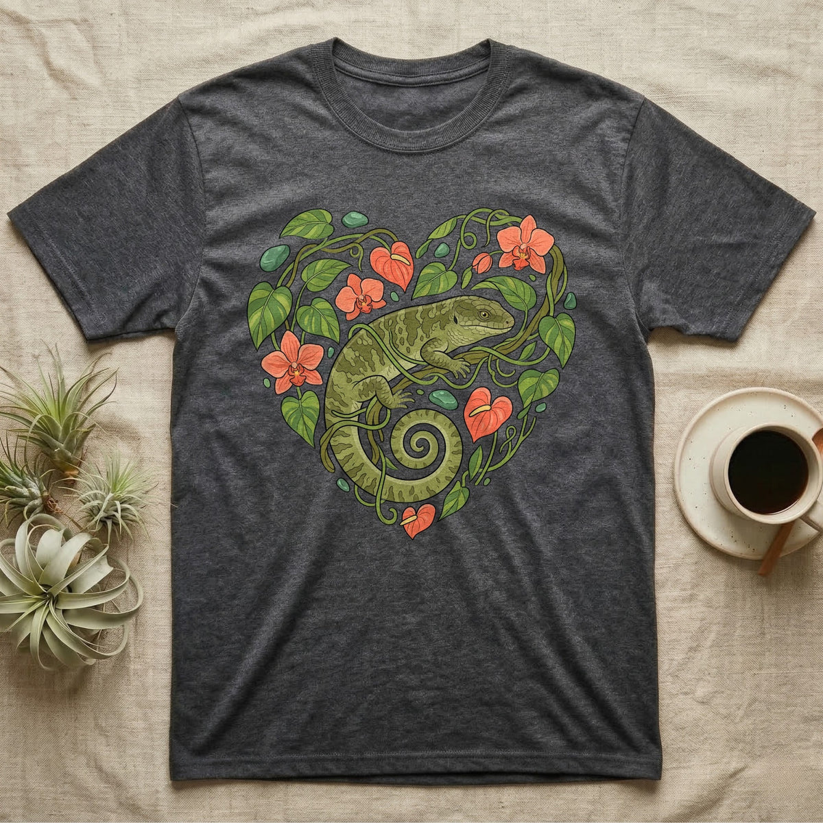 Dark grey t-shirt with a green gecko and coral flowers forming a heart.