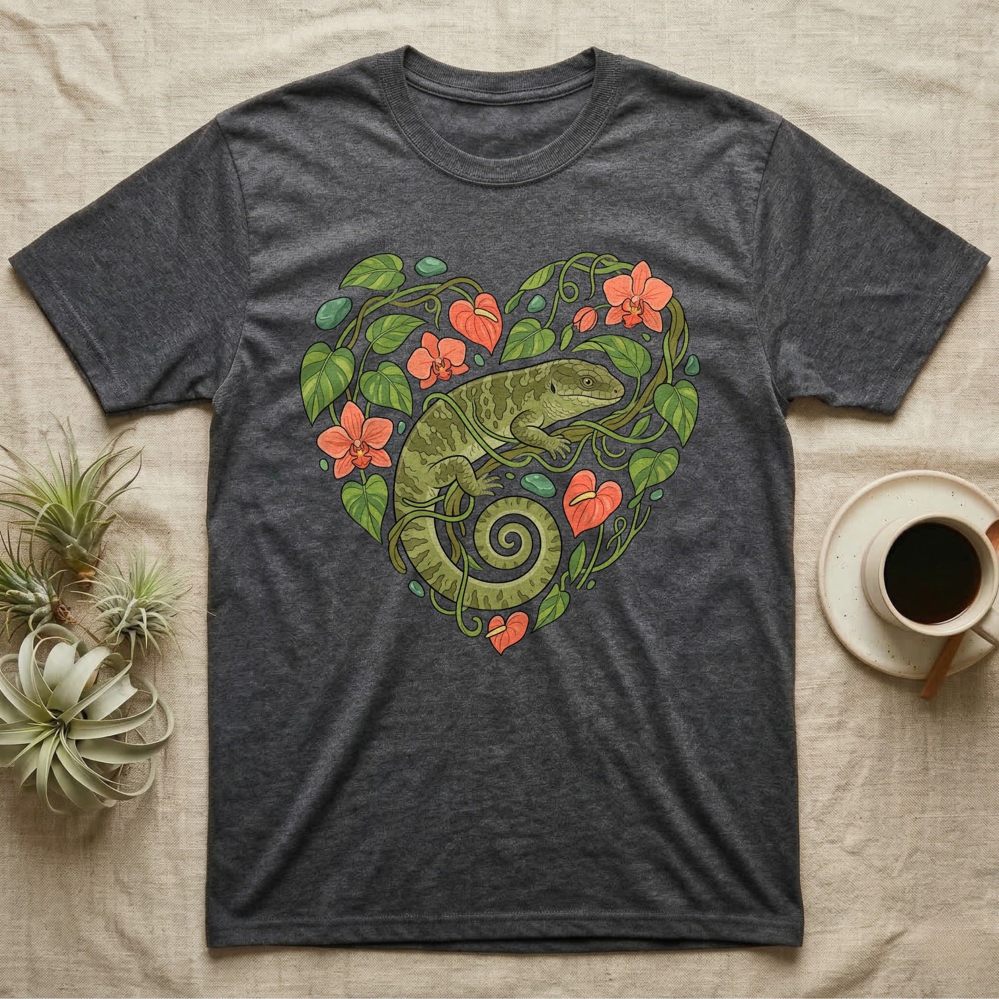 Dark grey t-shirt with a green gecko and coral flowers forming a heart.