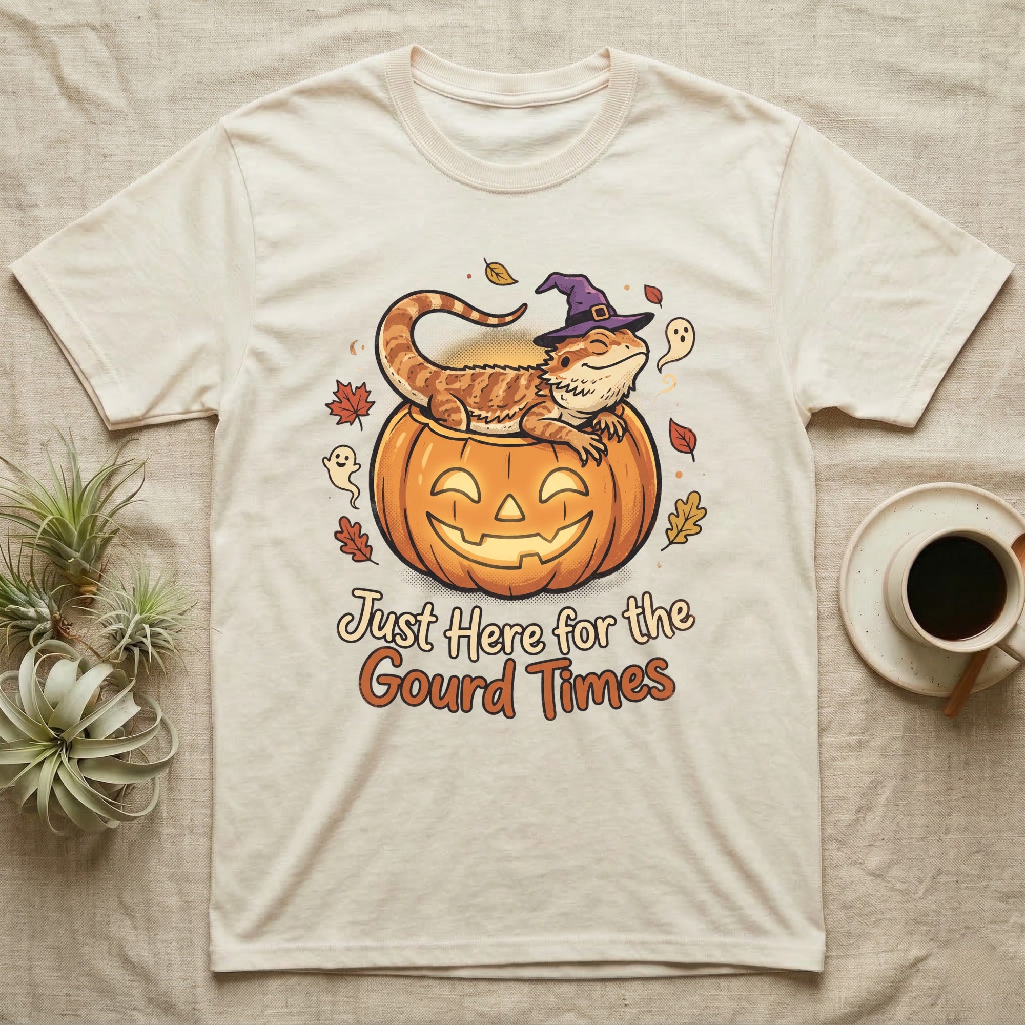 Bearded Dragon Gourd Times T-Shirt in Natural — Cartoon bearded dragon in a witch hat lounging in a jack-o'-lantern, "Just Here for the Gourd Times."