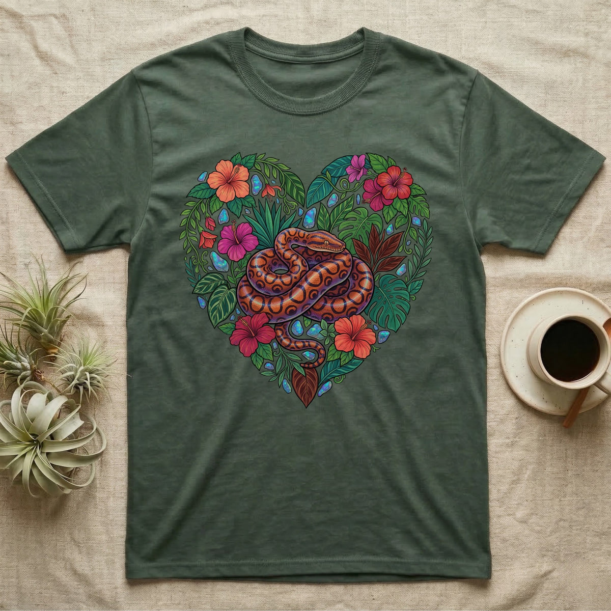 Green t-shirt with a heart-shaped floral design featuring a snake.