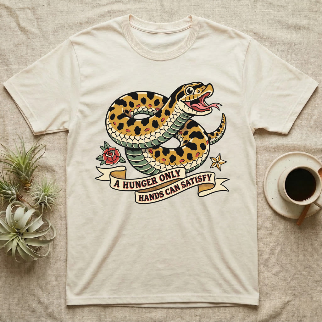 Hognose Hunger Flash T-Shirt in Natural — American-traditional tattoo-flash illustration of a hognose snake in a heroic coil with a banner reading the feeding-hunger line.