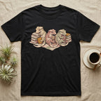 Gecko Book Club T-Shirt in Black — Warm storybook illustration of three crested geckos in a cozy reading row, each beside a tiny stack of books.