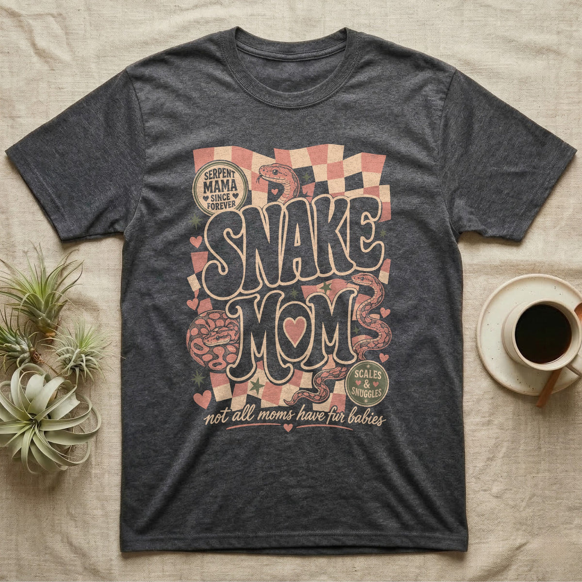 "Snake Mom" graphic tee with snakes, hearts, and checkered pattern.