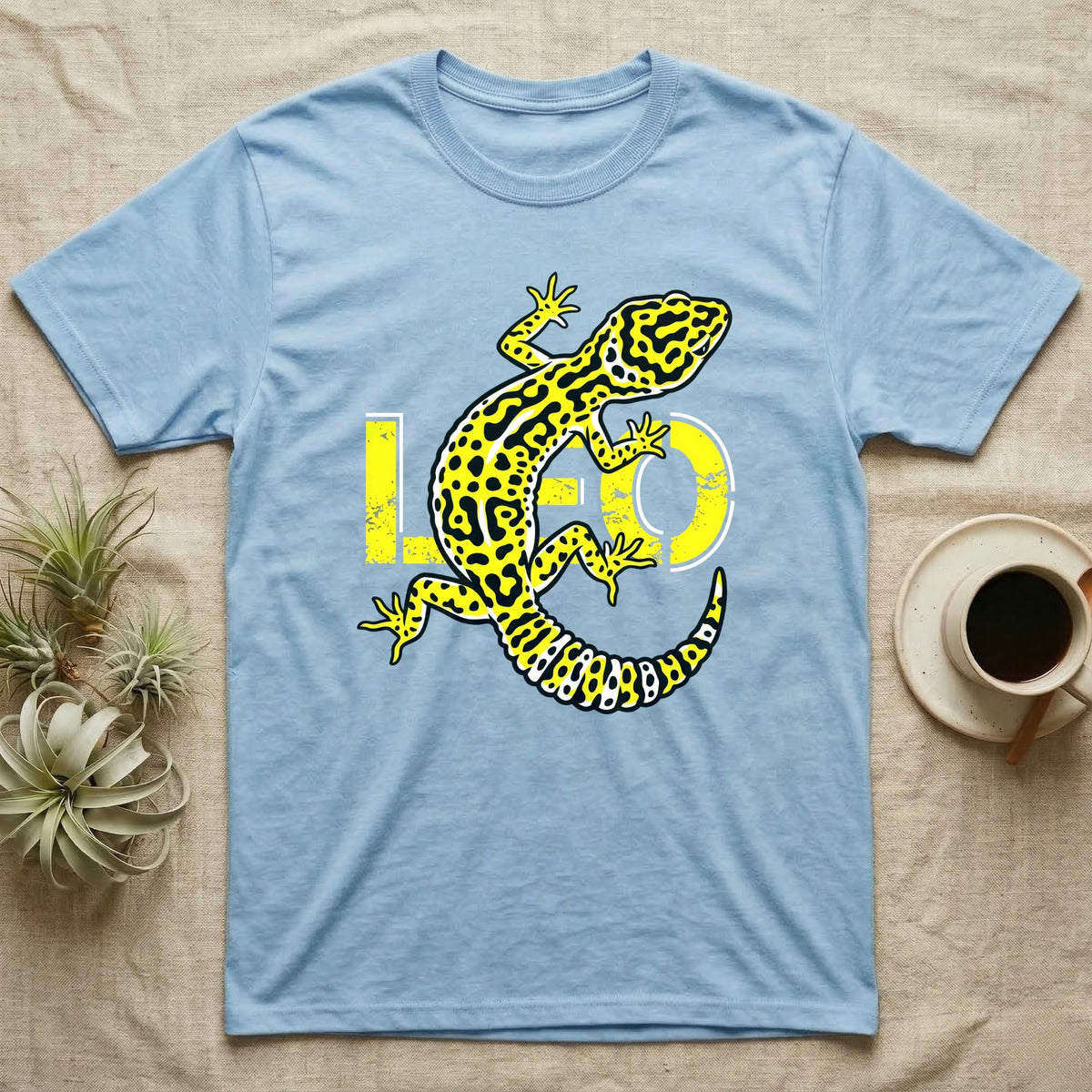 Light blue t-shirt with yellow and black leopard gecko design and "LO" text.