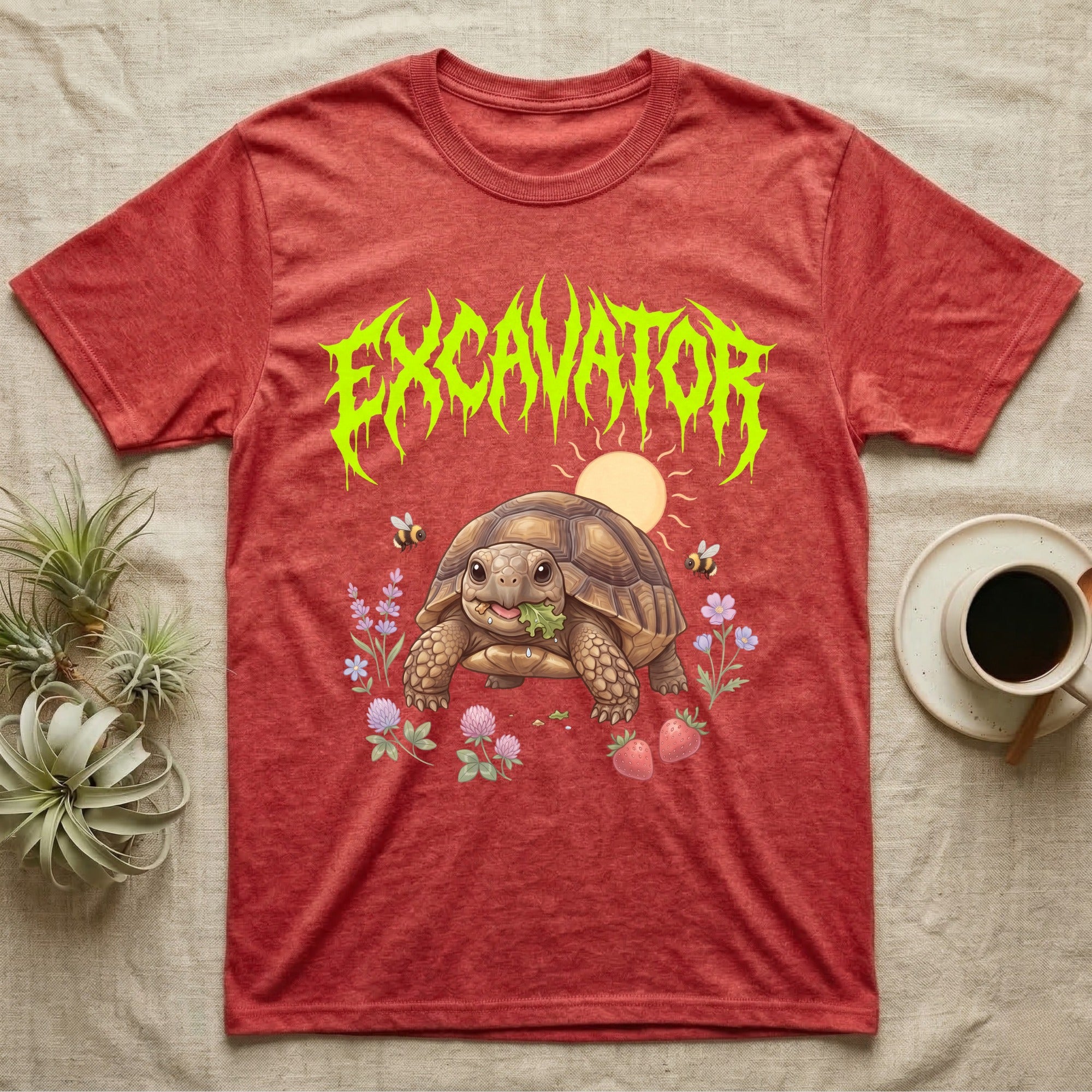 Russian Tortoise Feral T-Shirt in Heather Red — Chubby Russian tortoise munching a green in a pastel meadow under a spiky lime metal wordmark reading EXCAVATOR.
