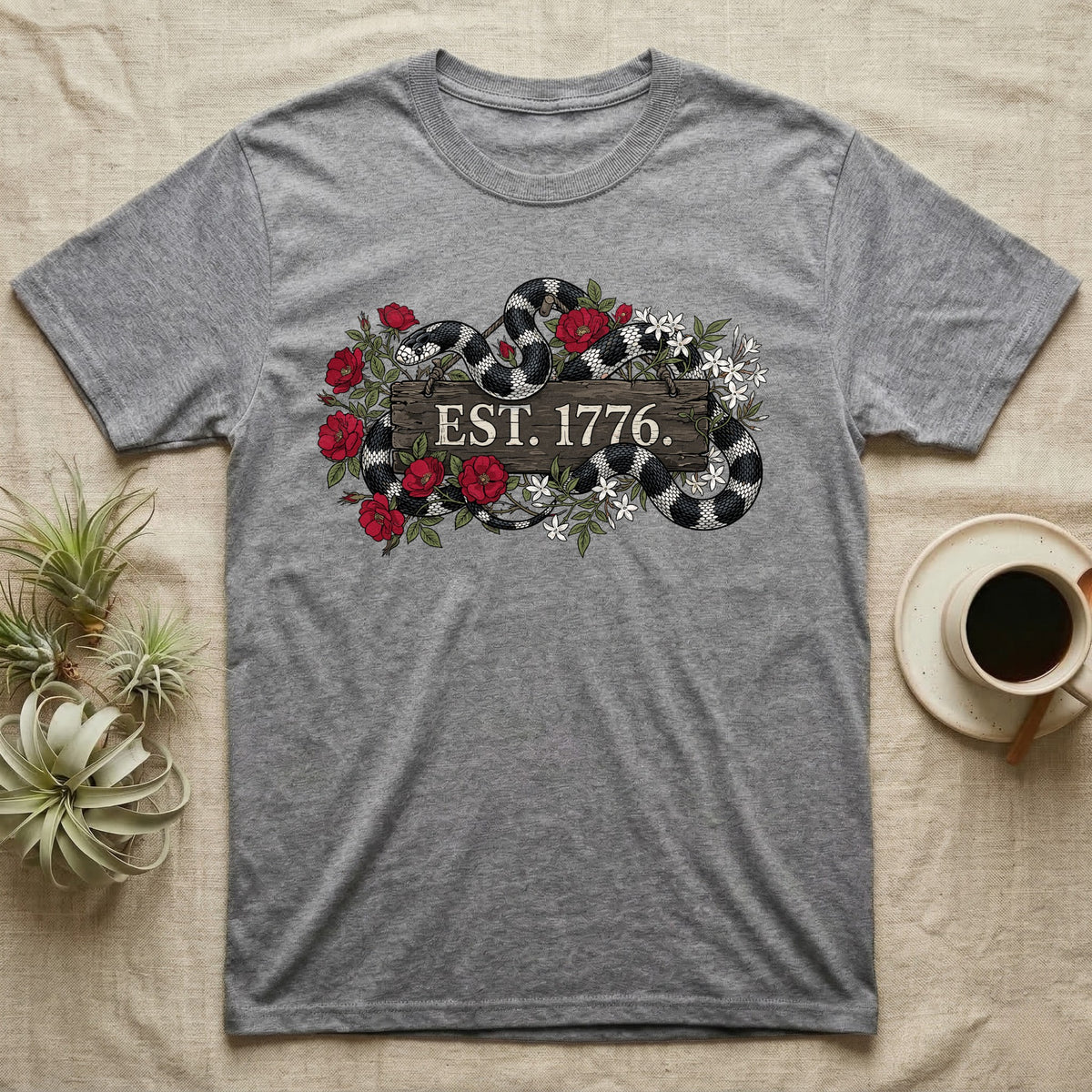Kingsnake Floral 1776 T-Shirt in Sport Grey — Black-and-white California kingsnake woven through roses and jasmine around a wooden sign reading Est. 1776.