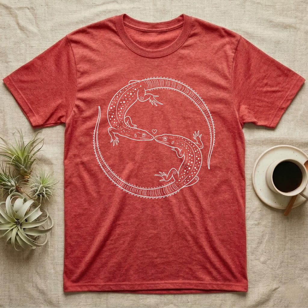 Ackie Monitor Roundel T-Shirt in Heather Red — Two ackie monitors in fine white line art, mirrored at 180 degrees around a tiny heart, tails sweeping outward.