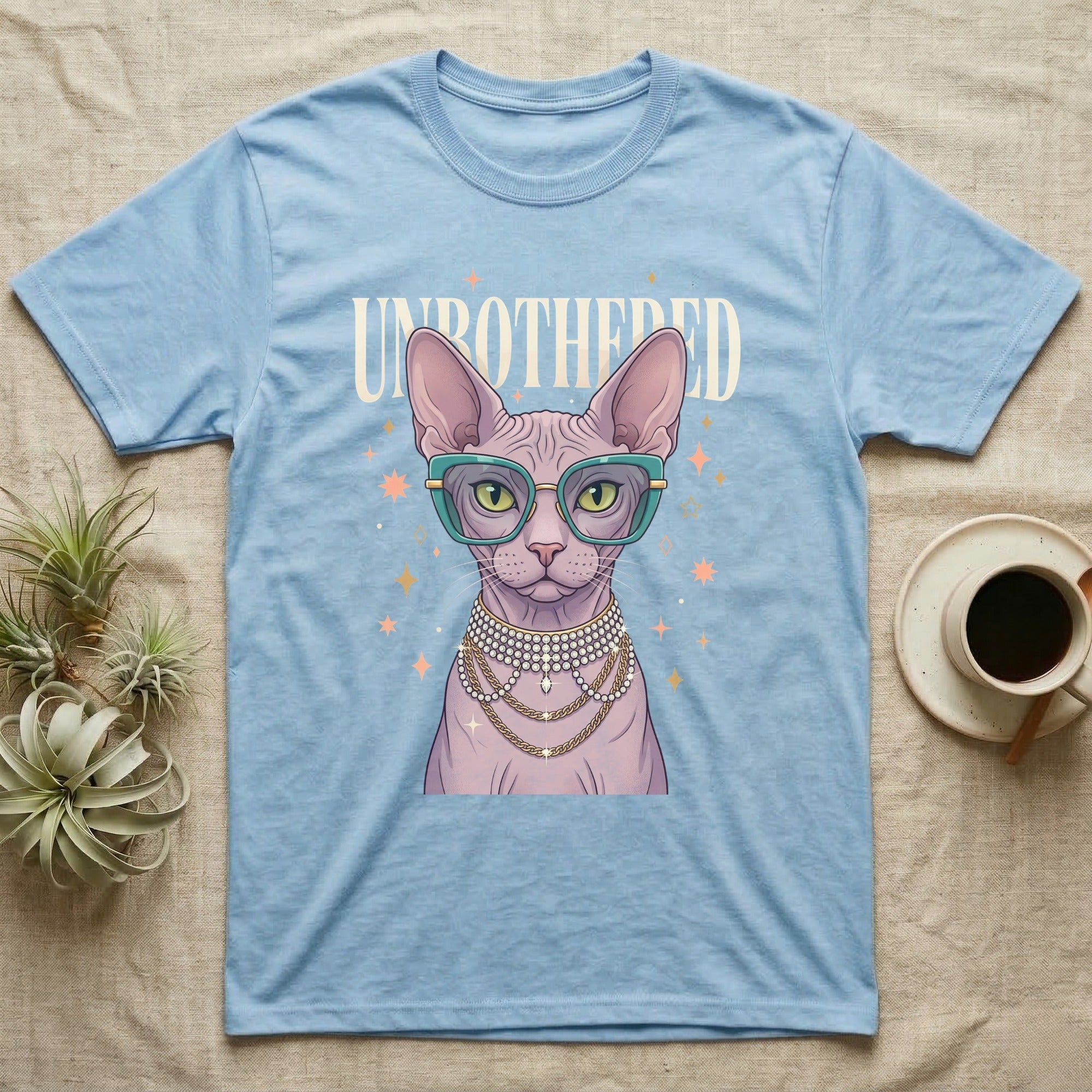 Light blue t-shirt with a Sphynx cat wearing glasses and jewelry.