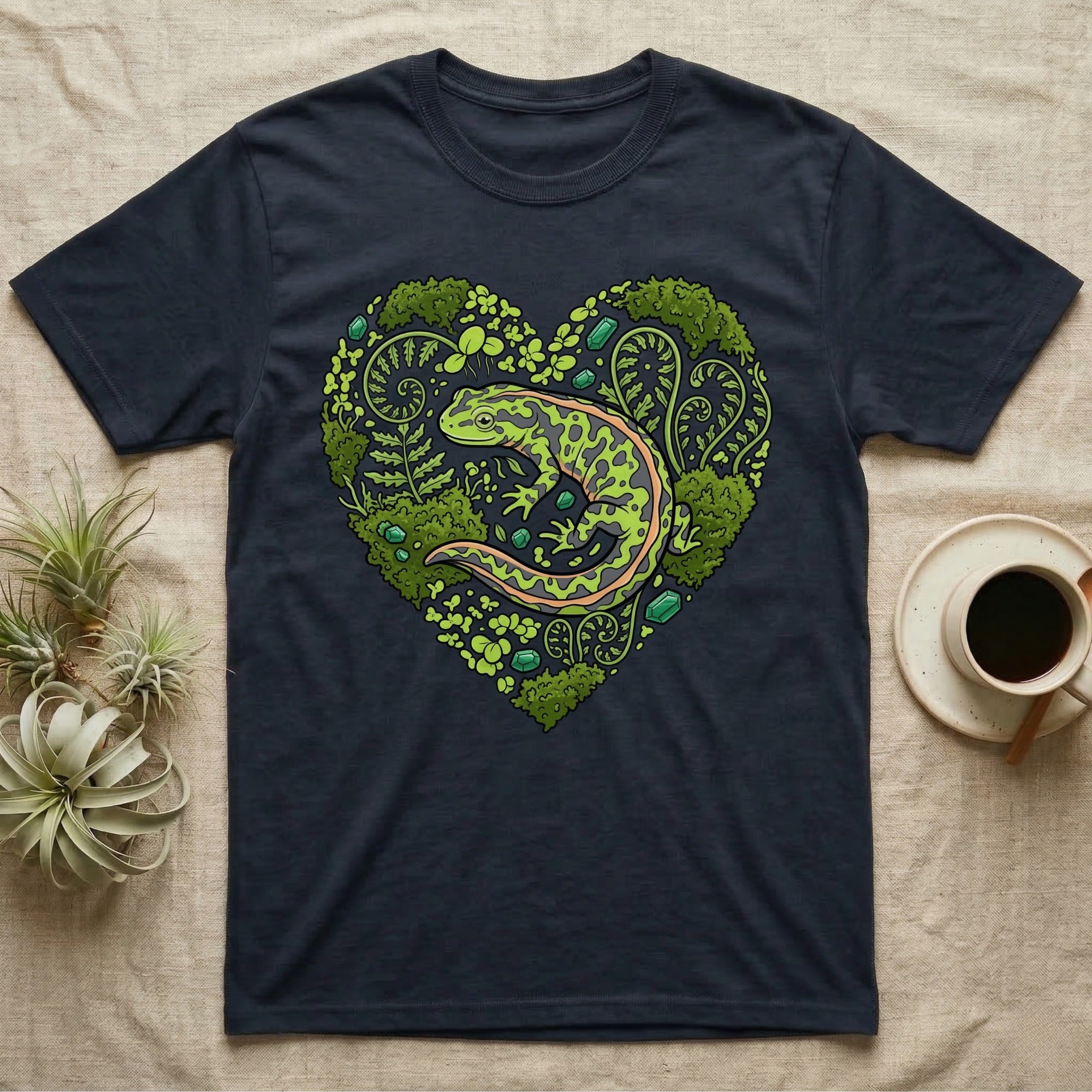 Dark t-shirt with a green salamander inside a heart-shaped floral design.